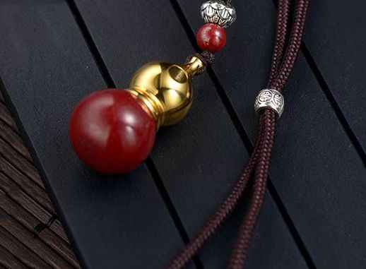Golden Cinnabar Gourd Pendant with Sacred Mantra Projection